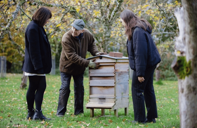 Beekeeper with hive in grounds of Berwick Lodge